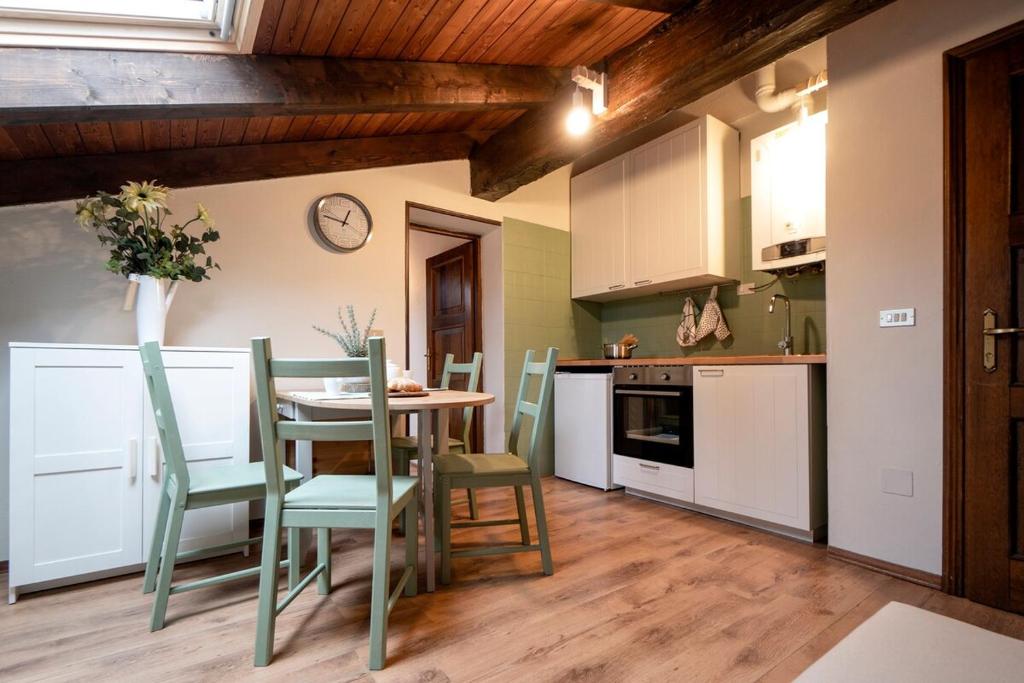 a kitchen with a table and chairs in a room at Una mansarda in montagna in Fanano