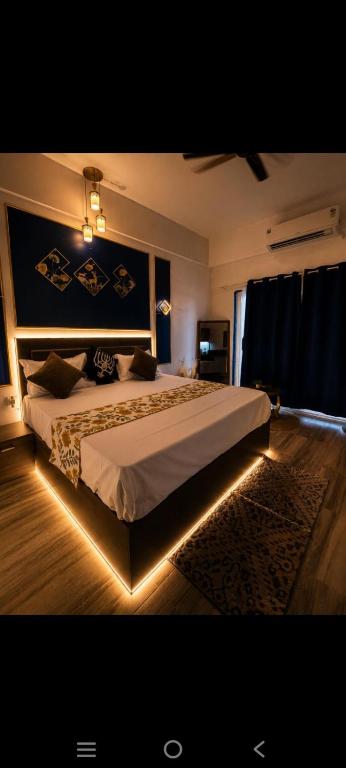 a bedroom with a large bed with lights on it at Aashirwad Retreat in Greater Noida
