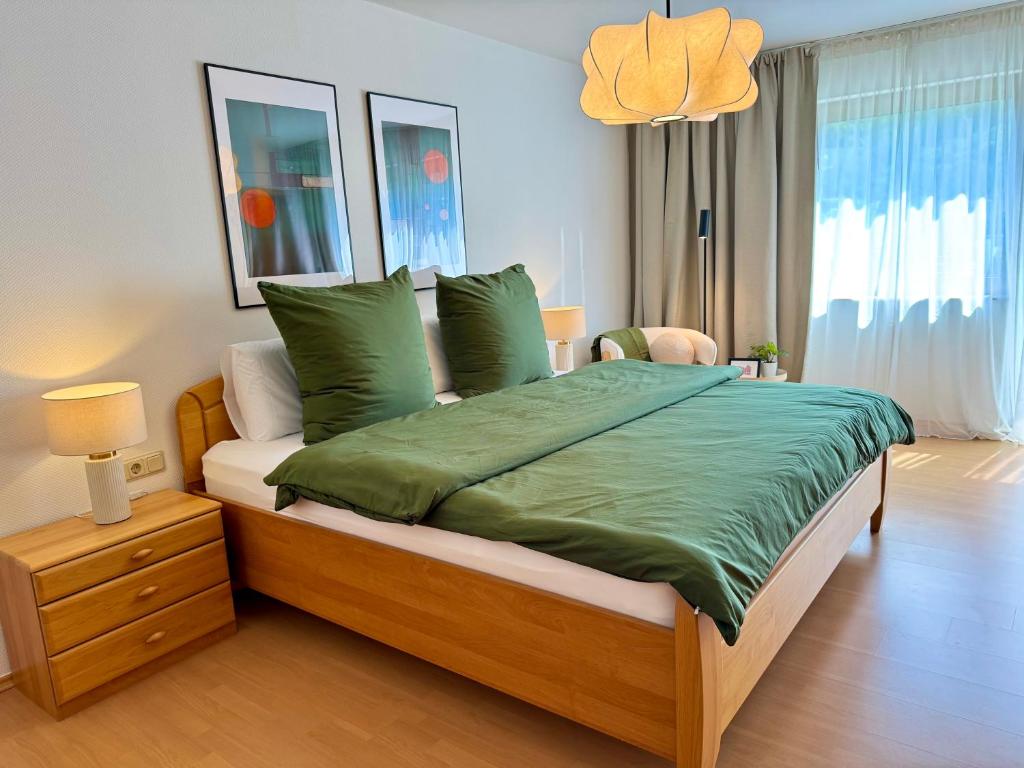 a bedroom with a large bed with green sheets at Ferienhaus Burgblick am Hang in Bernkastel-Kues