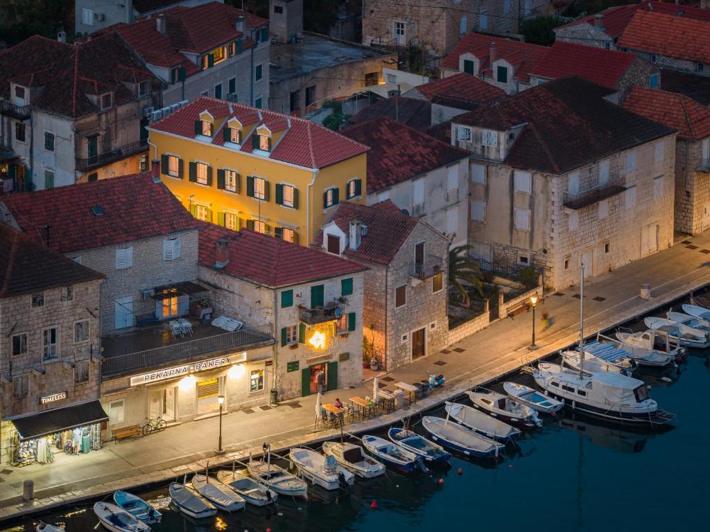 a group of boats parked in a marina at night at Palazzo Viridis Heritage Hotel in Milna