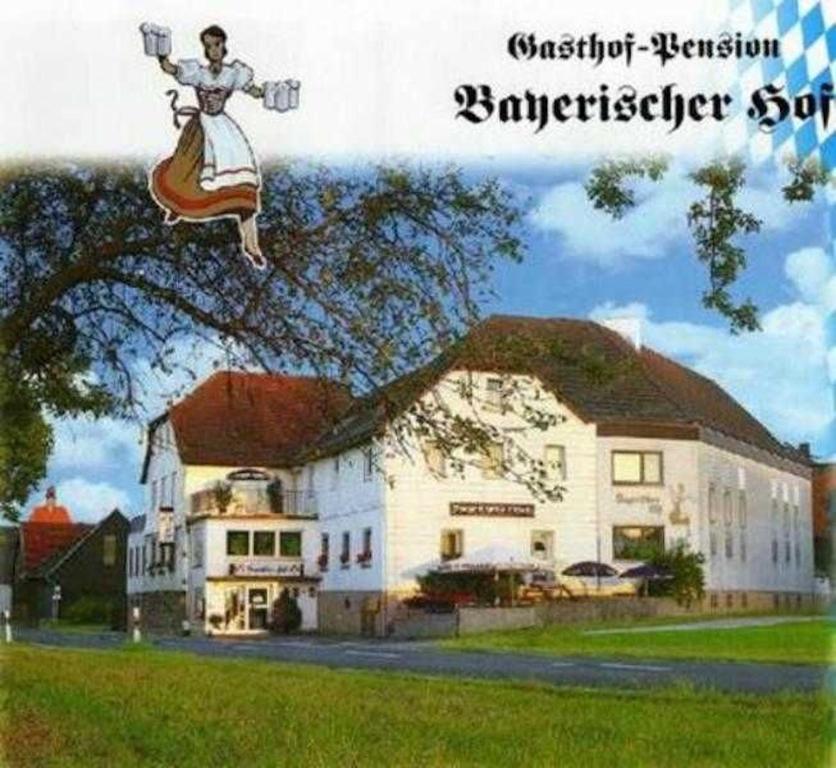 a picture of a large white house with a person in the air at Bayerischer Hof in Amorbach