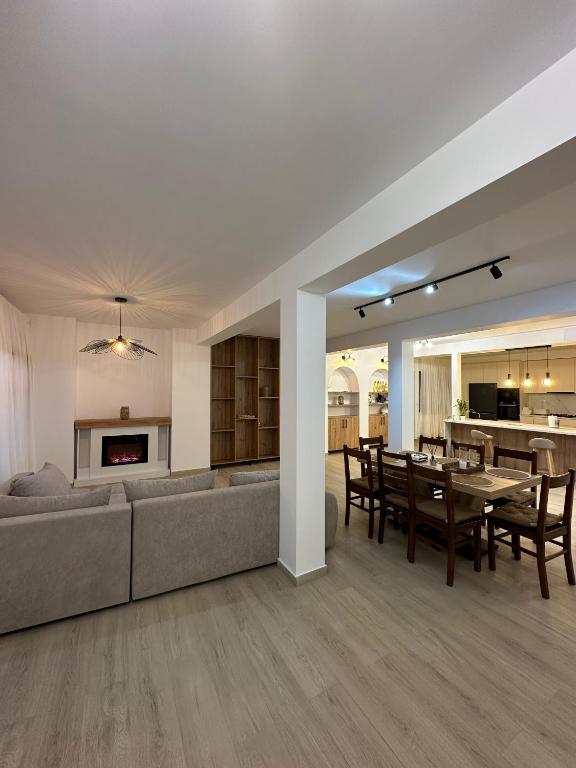 a living room with a couch and a dining room at Stai Ca Acasă in Slănic-Moldova
