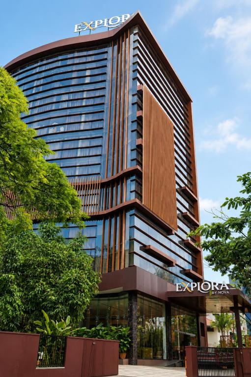 a tall building with a sign on top of it at Hotel Explora Calicut by Nova in Kozhikode