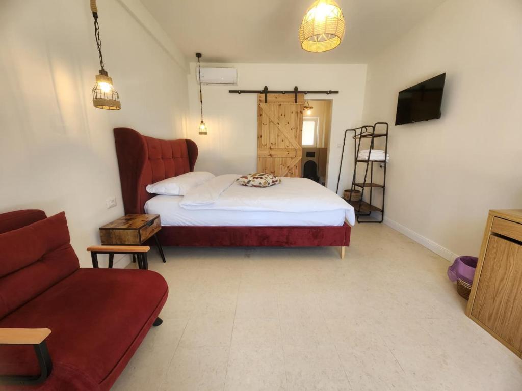 a bedroom with a bed and a couch at Eunoia in Vama Veche
