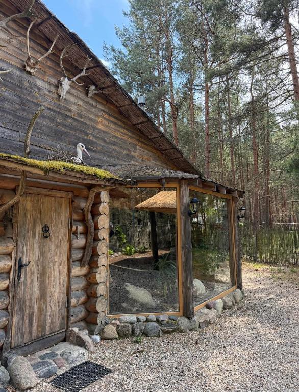 a log cabin with a large window in the front at Lilaste in Lilaste