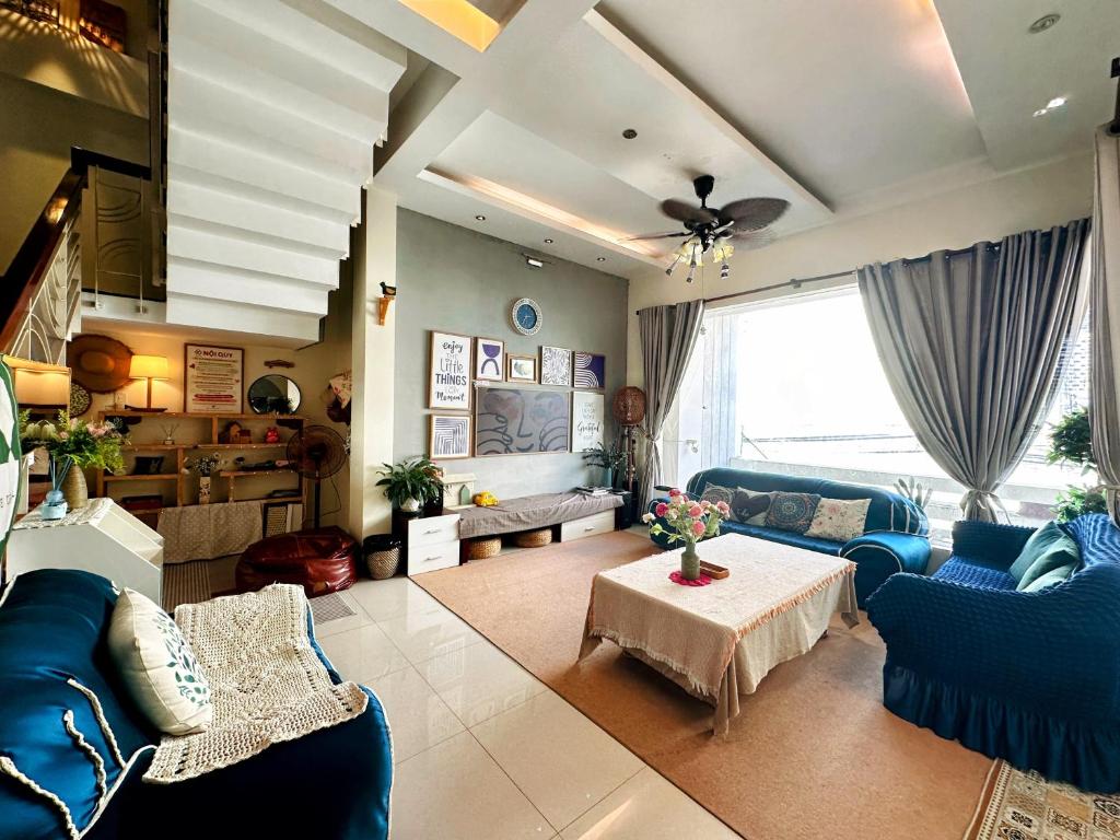 a living room with blue couches and a table at Annie.homestay 12NM in Nha Trang