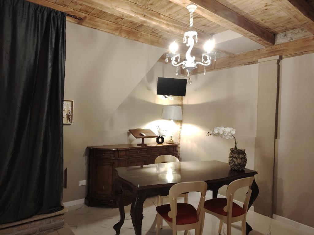 a dining room with a table and chairs and a chandelier at Domus Mater in Vigonza