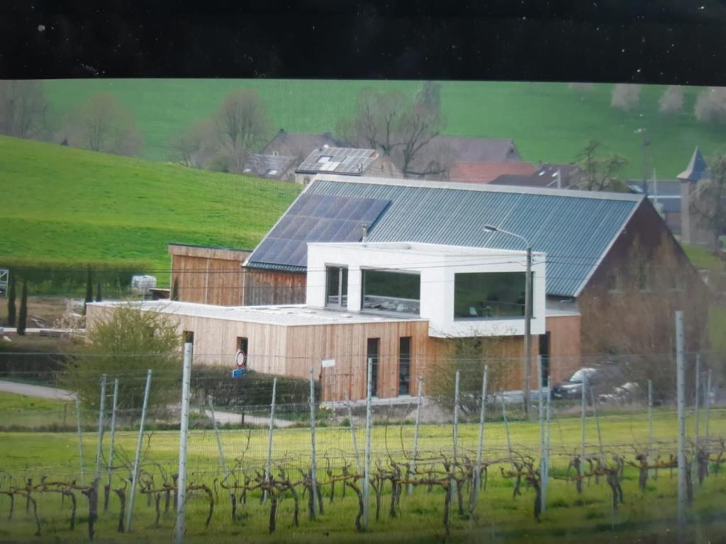 a house with solar panels on top of it at Wijndomein Zwaeneberg in Voeren