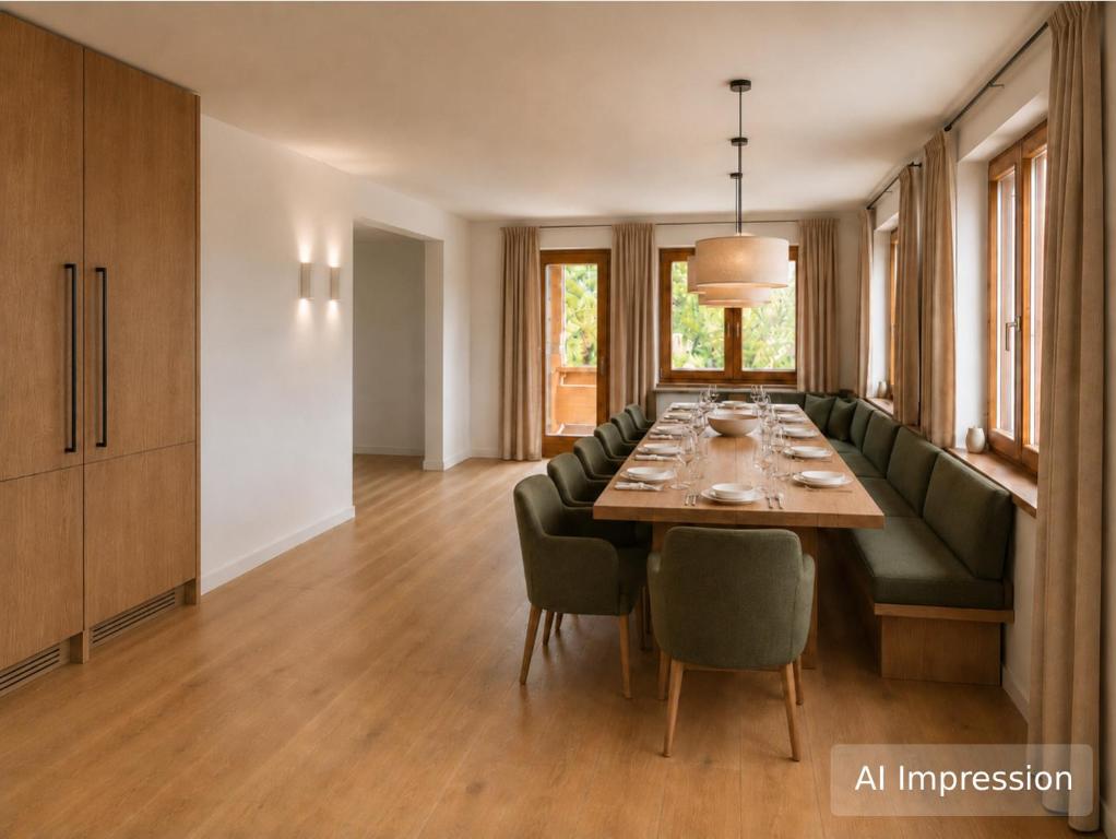 a dining room with a table and a green couch at Haus Lina in See
