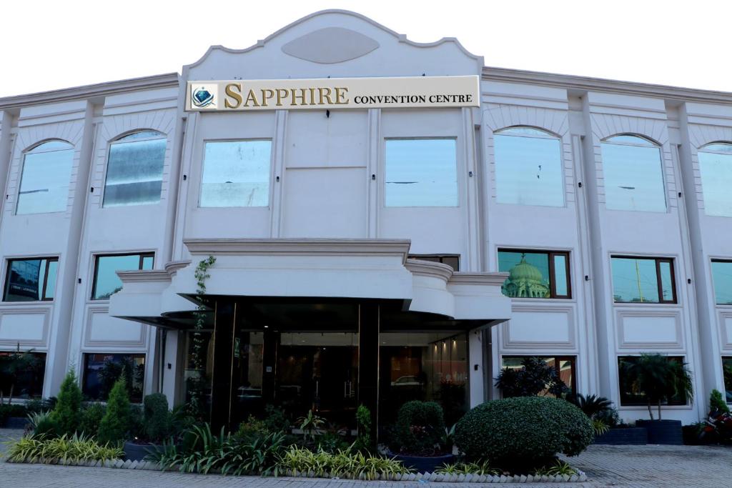 a white building with a sign that reads sapphire consultation centre at Sapphire Hotel & Convention Centre in Baddi