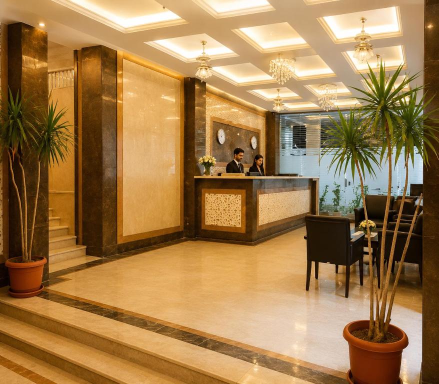 a lobby of a hotel with people at a counter at Bianco Matrouh Hotel in Marsa Matruh