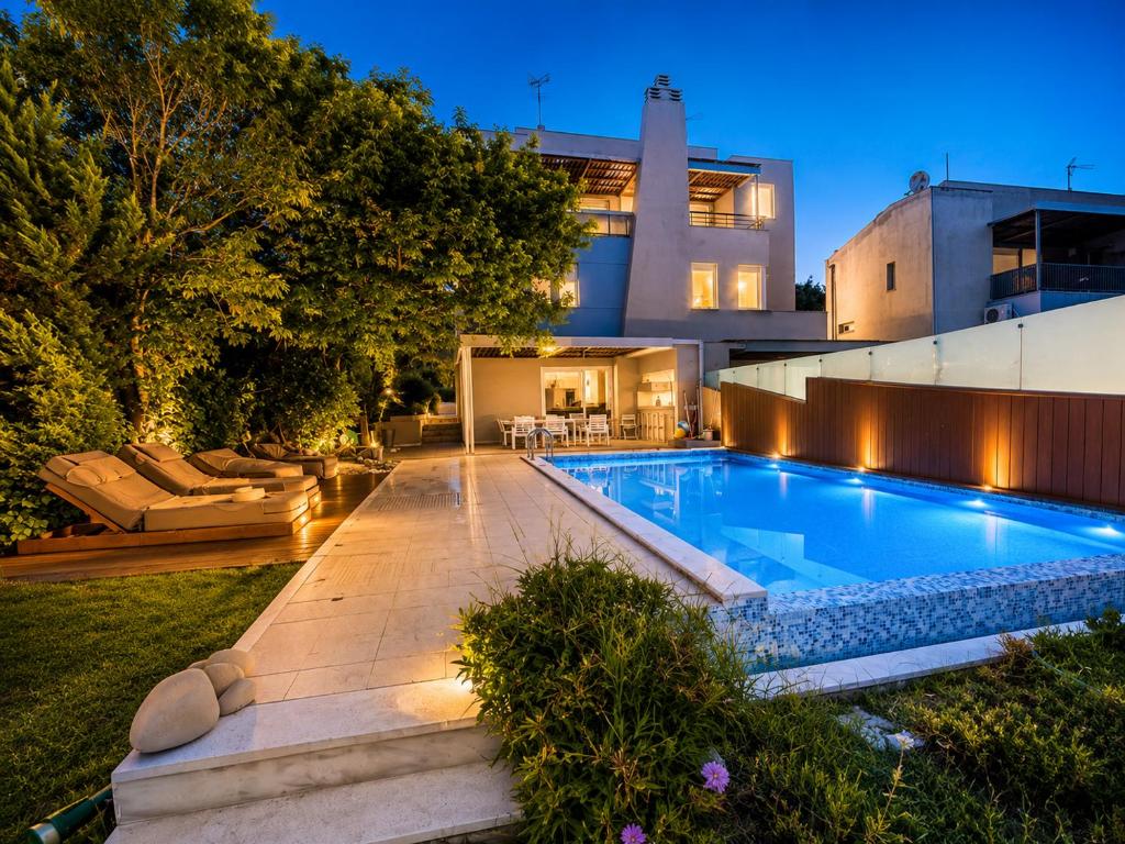 a swimming pool in the backyard of a house at Villa Magnifica - Private Pool, Elevator & Sea View in Paliouri