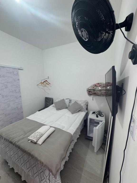 a white room with a bed and a lamp at Ebeneze in Nova Friburgo
