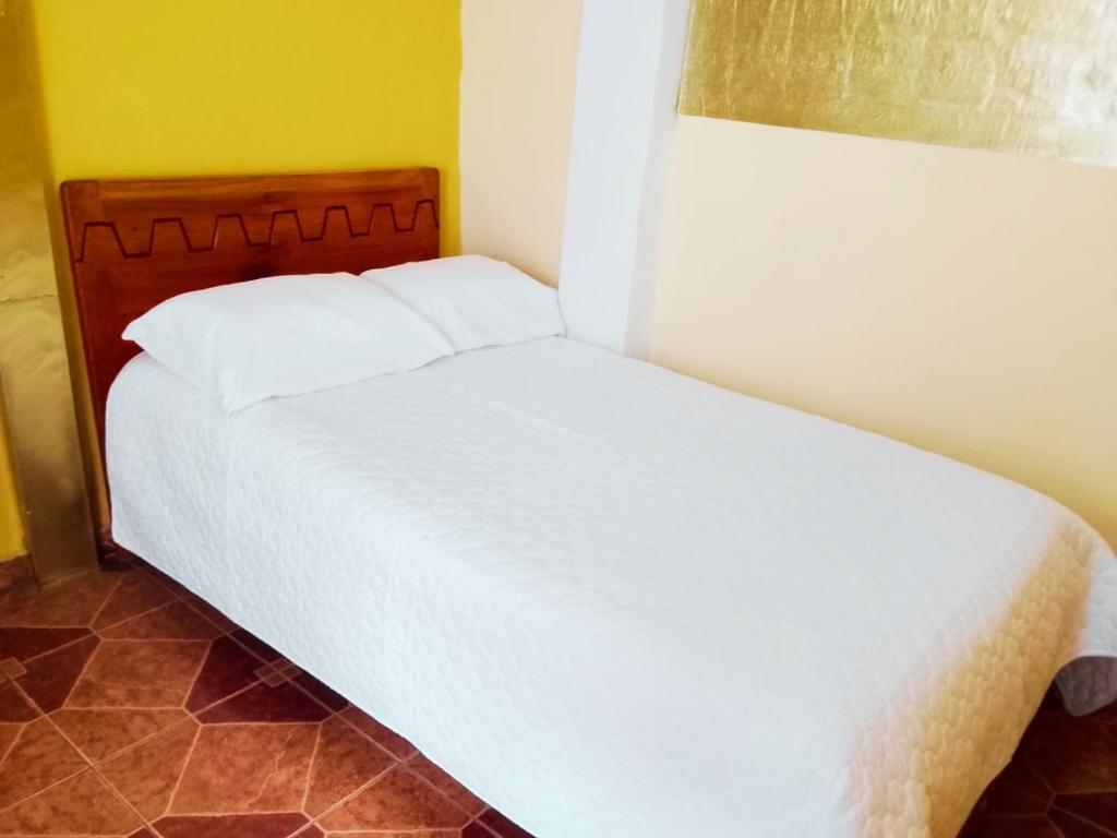 a bedroom with a white bed in a room at 1 BR Room 1 floor Cusco in Cusco