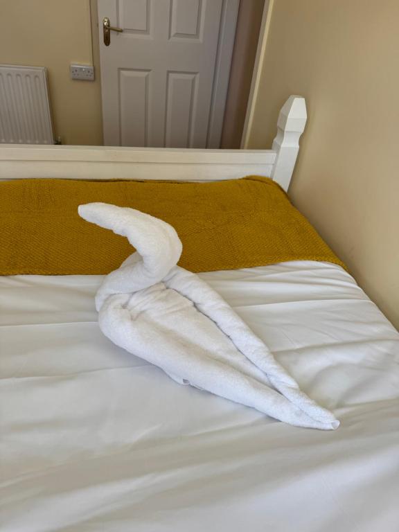 a white towel laying on top of a bed at Erris house in Belmullet