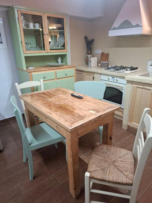 a kitchen with a wooden table and chairs at LavenderFarmhouse 2 in Nafpaktos