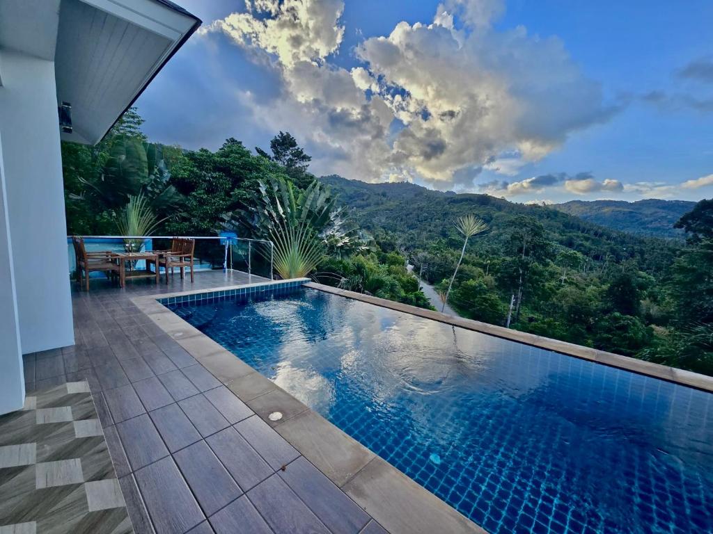 a swimming pool with a view of the mountains at Keya Mountain View Pool Villa Samui in Ban Thung