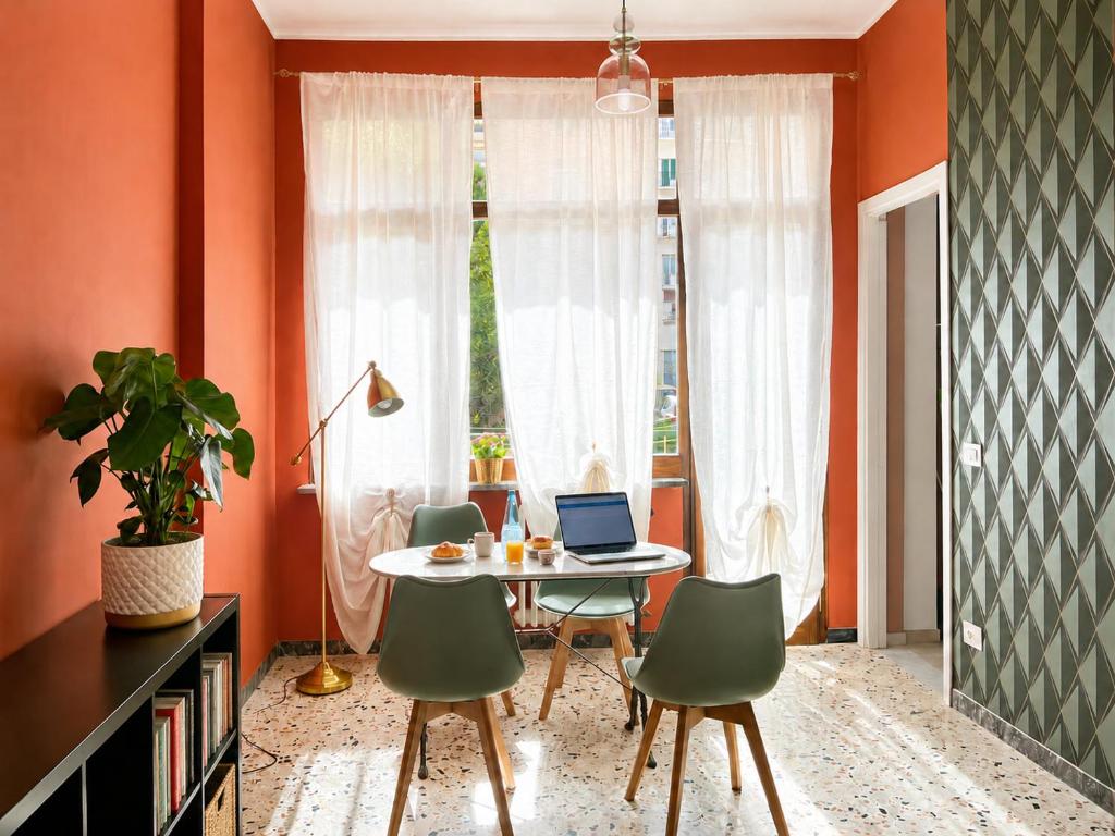 a dining room with a table with a laptop on it at Interi Appartamenti in Centro - Holiday & Wi-Fi Ultra in Campobasso