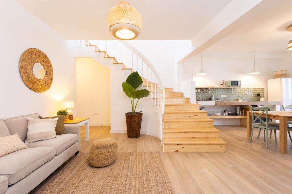 a living room with a couch and a staircase at El Valle apartment centro Orotava in La Orotava