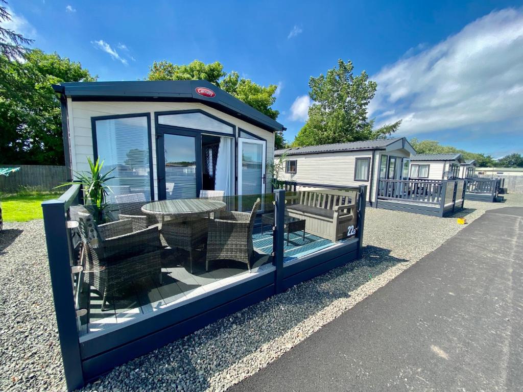 a tiny house with a table and benches on the street at Debran Lodge in Angus