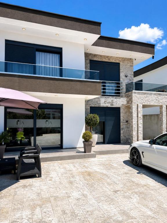 a white car parked in front of a house at Villa Hana in Bar