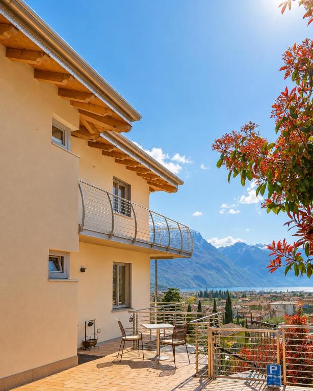 a house with a patio with a table and chairs at View & Chill Apartment in Riva del Garda