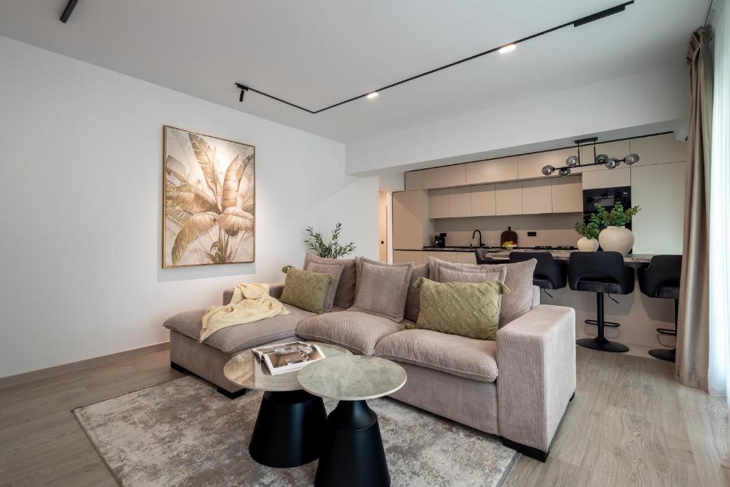 a living room with a couch and a table at Celeste Apartment 2BDR Parking in Bucharest