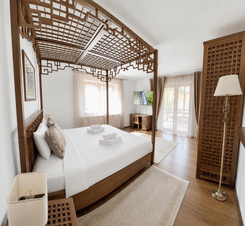 a bedroom with a large bed with a wooden canopy at UMANI Retreat in Buşteni