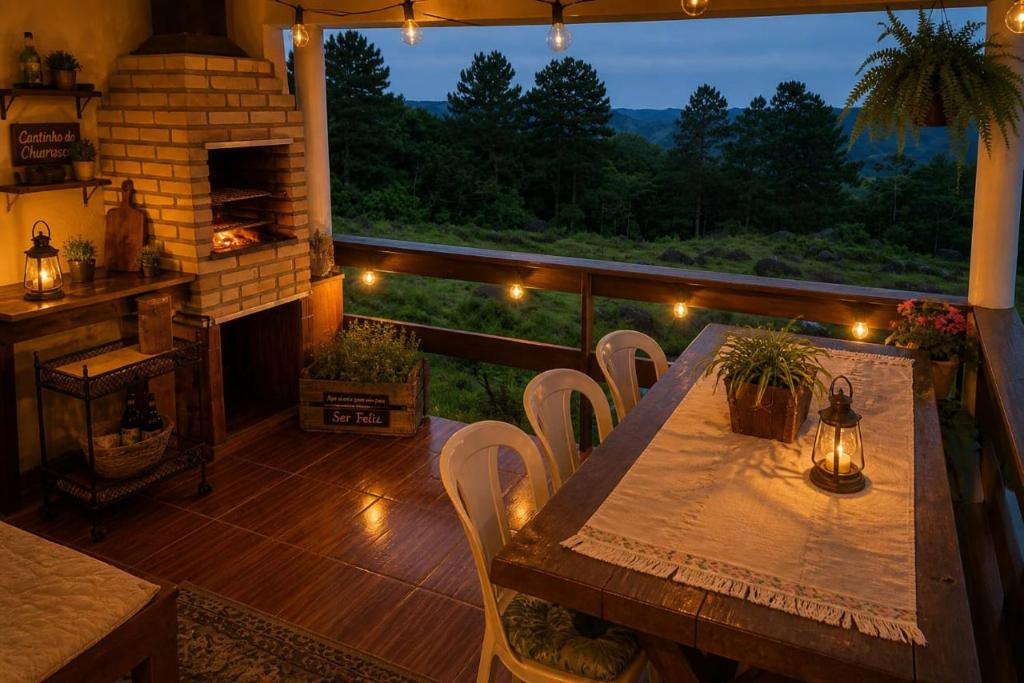 a wooden table and chairs on a balcony with a fireplace at Fazenda Monte Verde a Morada do Muriqui in São Francisco Xavier