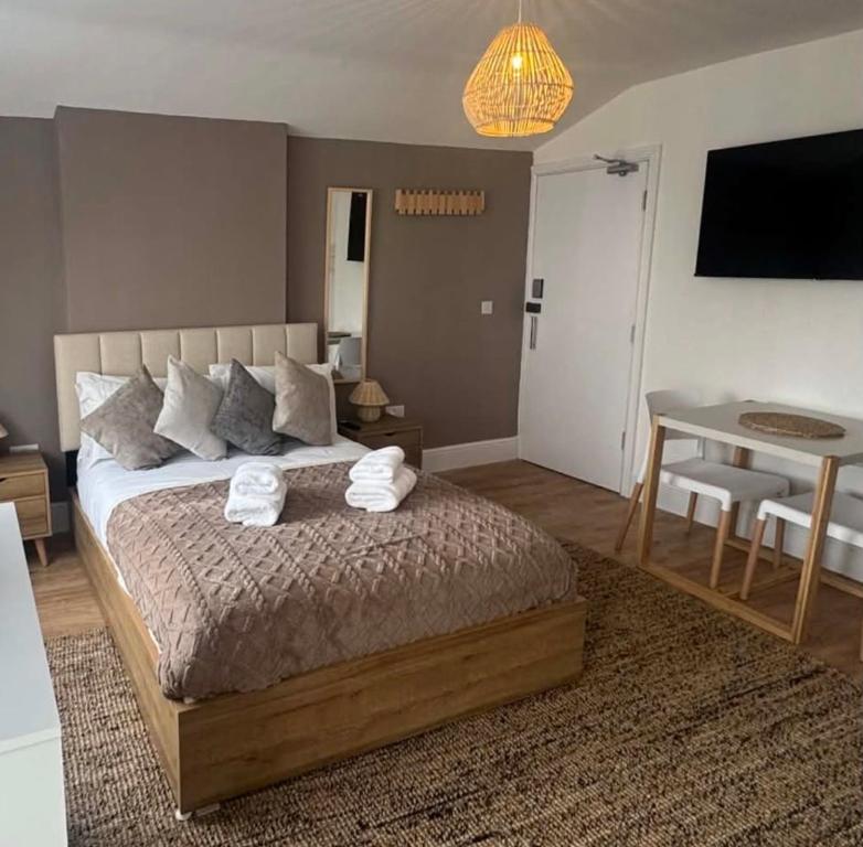 a bedroom with a bed with two towels on it at Glan Neigr Room 11 in Rhosneigr