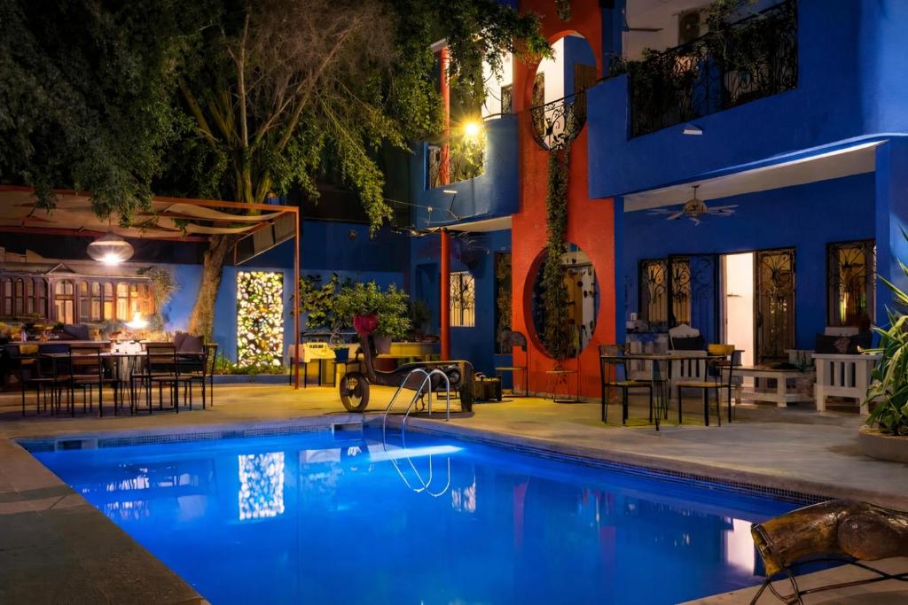 a pool in front of a hotel at night at Loman Art in Dakar