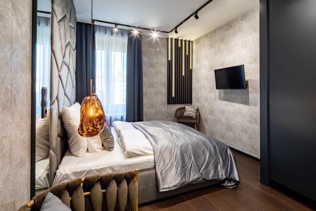 a bedroom with a bed and a tv in it at Super Central - Modern & Luxury in Budapest