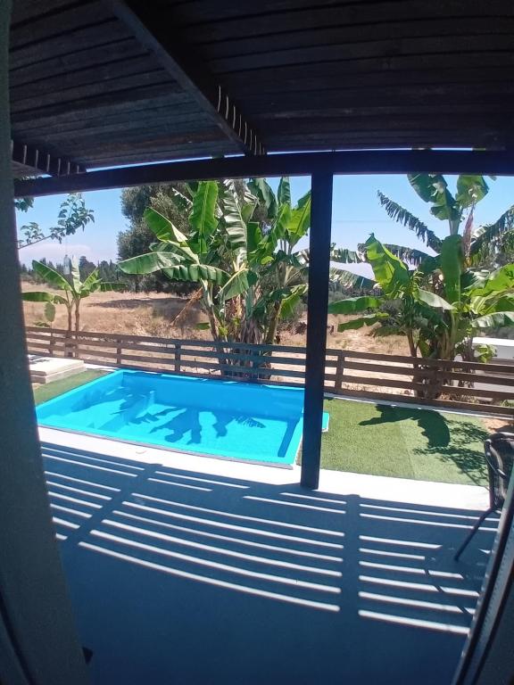 a view of a swimming pool through a window at Elysian Suites in Ratzaklíon