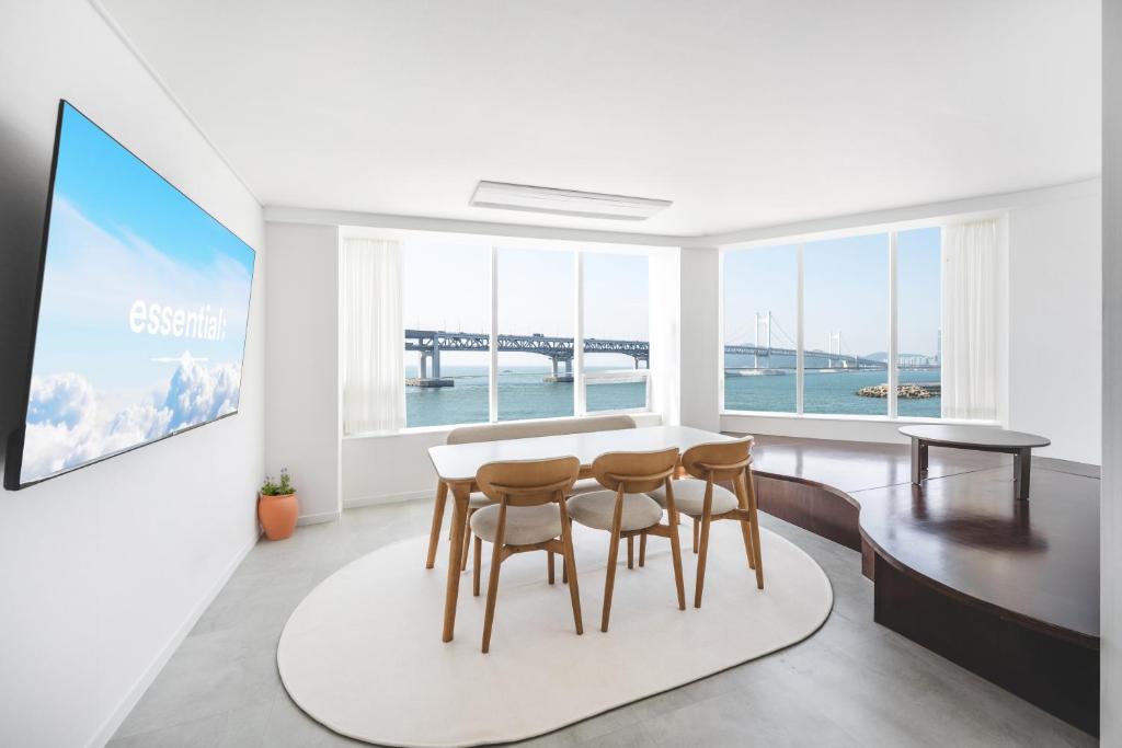 a dining room with a table and four chairs at 지니스테이 in Millak-tong