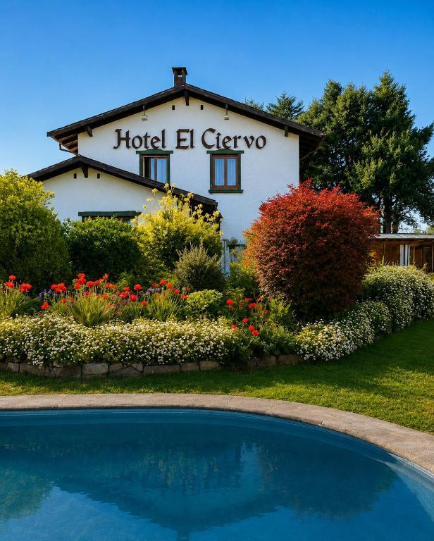 a hotel el greco building with a swimming pool at Hotel El Ciervo in Villarrica