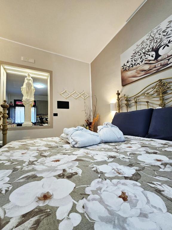 a bedroom with a large bed with flowers on it at Casa Vacanze VENER - Venosa in Venosa