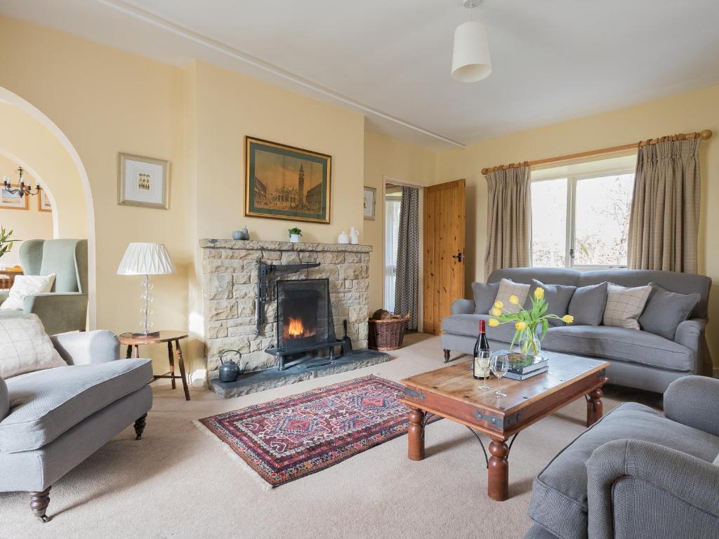 a living room with a couch and a fireplace at Glaisdale in Pickering