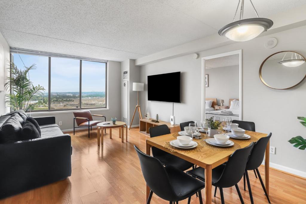 a dining room and living room with a table and chairs at Relaxing Arlington Apt - Pool - near Pentagon City in Arlington