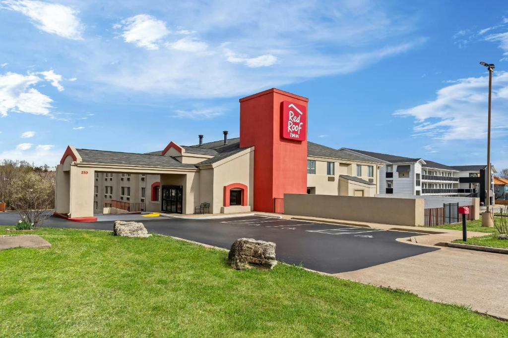 a building with a coca cola sign in a parking lot at Red Roof Inn Branson in Branson