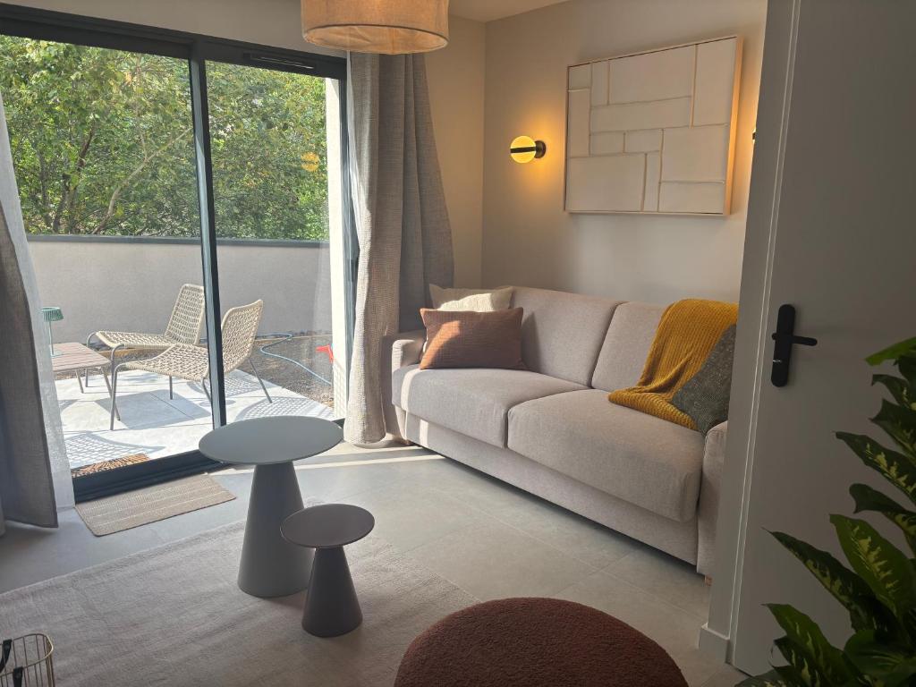 a living room with a couch and a table at Résidence les 3 volcans 4 étoiles in Clermont-Ferrand