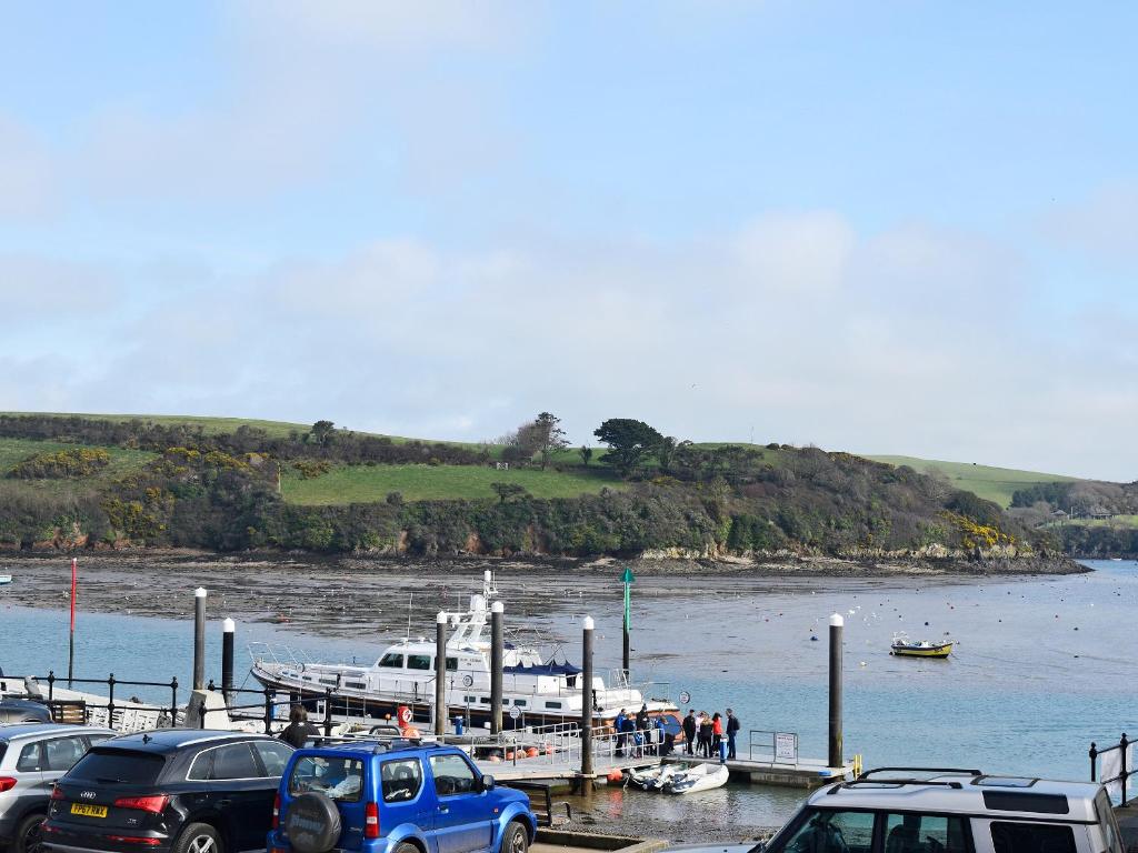 a group of cars parked at a dock with a boat at Ferrydown in Salcombe