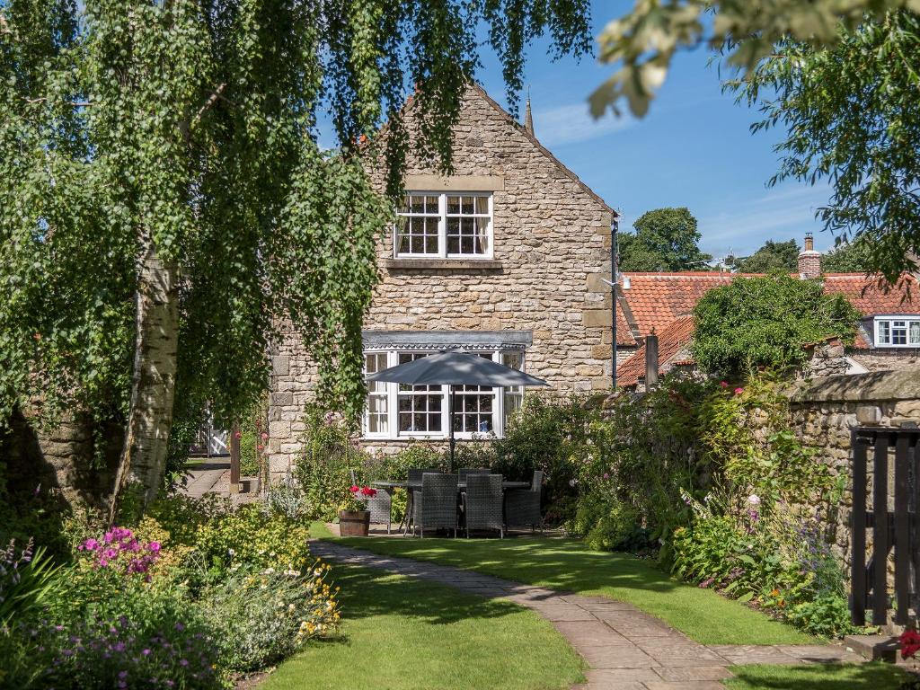 a stone house with a garden in front of it at Saltersgate in Pickering