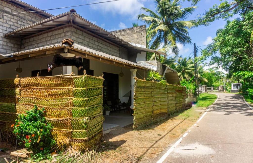 a house with a fence in front of it at River Island Villa in Ahangama
