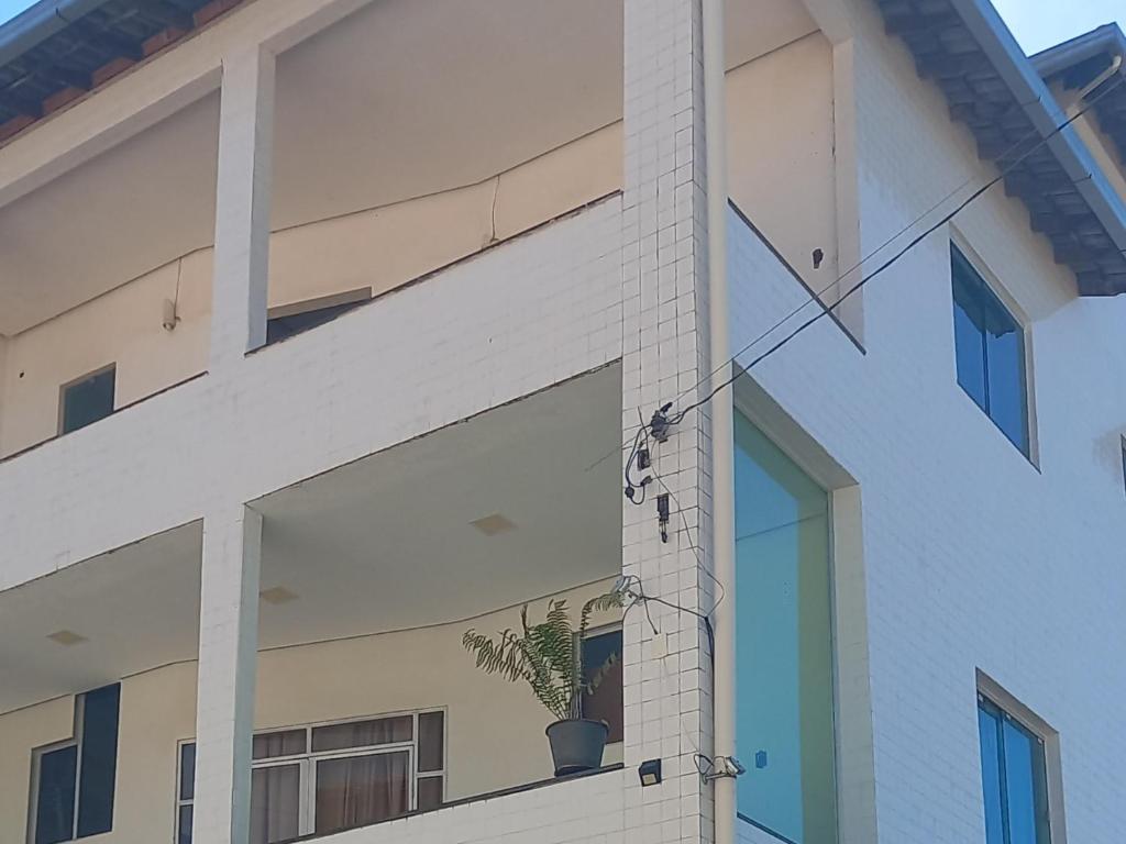 a bird perched on the side of a building at Apartamento in Montes Claros