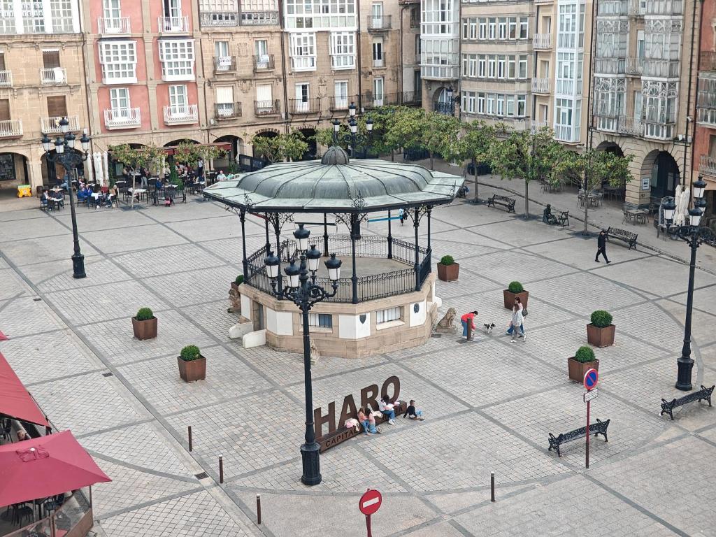 a city square with a plaza with people walking around at El Sol de la Paz in Haro