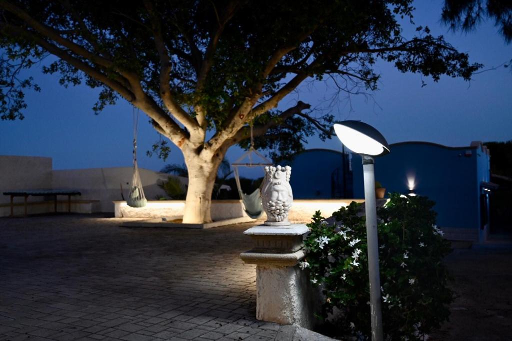 a street light next to a tree at night at La Casa del Vento Plemmirio in Plemmirio