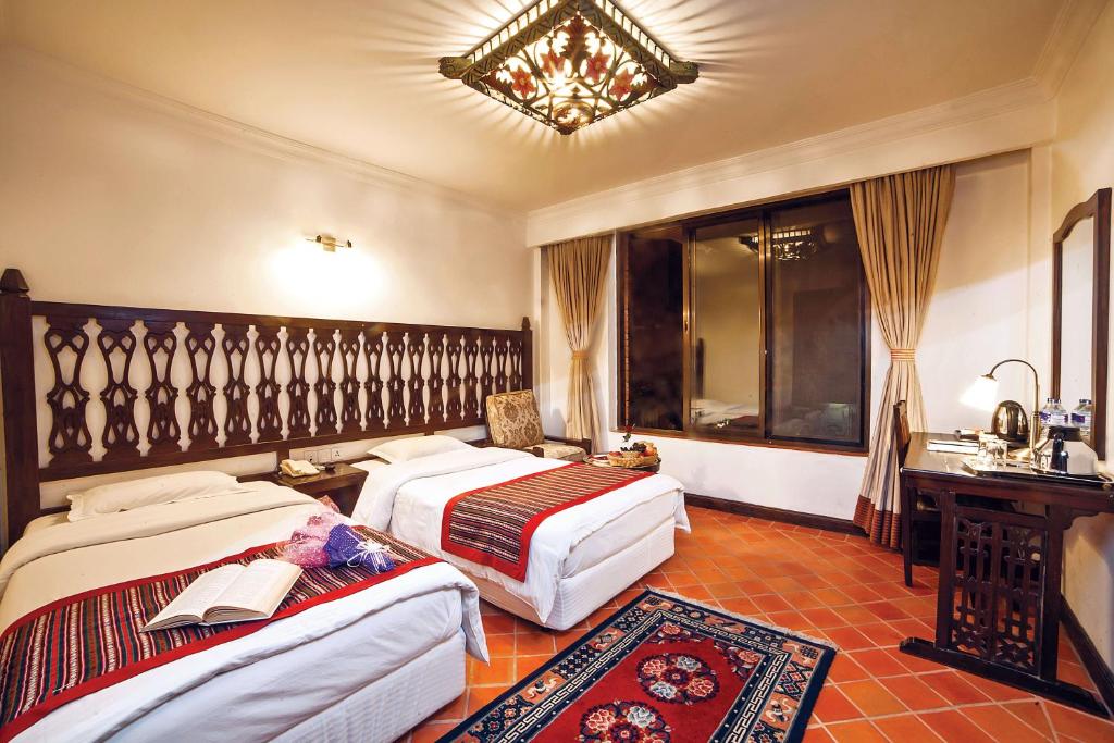 Postel nebo postele na pokoji v ubytování Hotel Manaslu