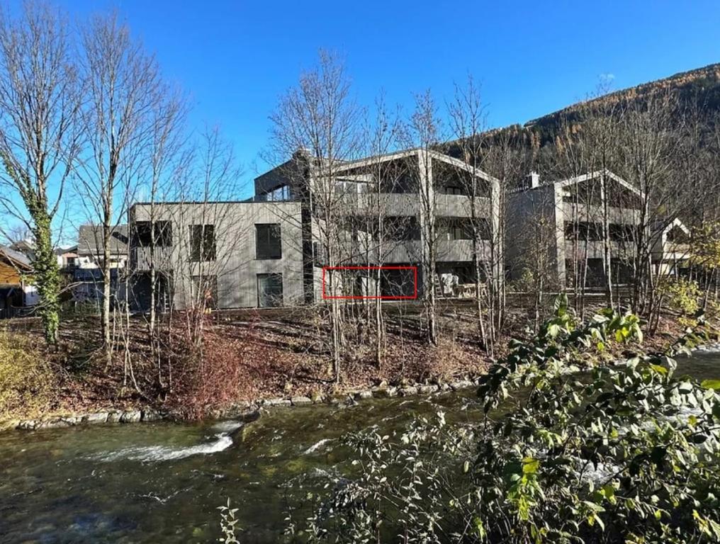 an unfinished building with two buildings in the background at Design Apartment Schladming in Schladming