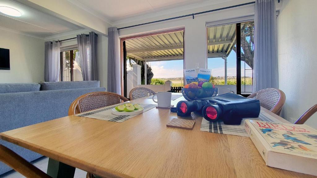 a dining room table with a camera on top of it at Paradise Beach Cottage #20 in Jeffreys Bay