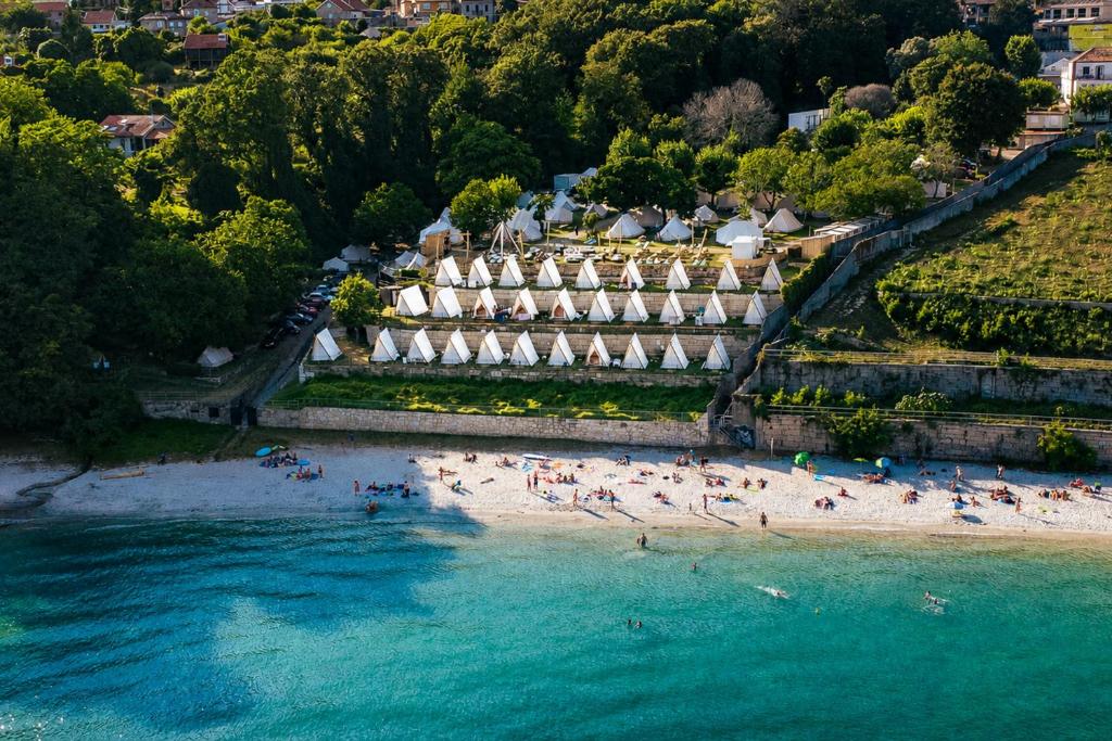 an aerial view of a beach with people in the water at Kampaoh Ría de Vigo in Moaña